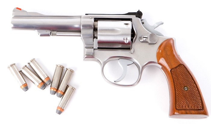 357 magnum revolver with several rounds of ammunition